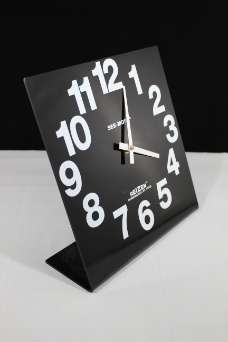 Large print square analog clock with white numbers on a black face