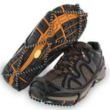 An elastic device with metal rings stretched over hiking shoes